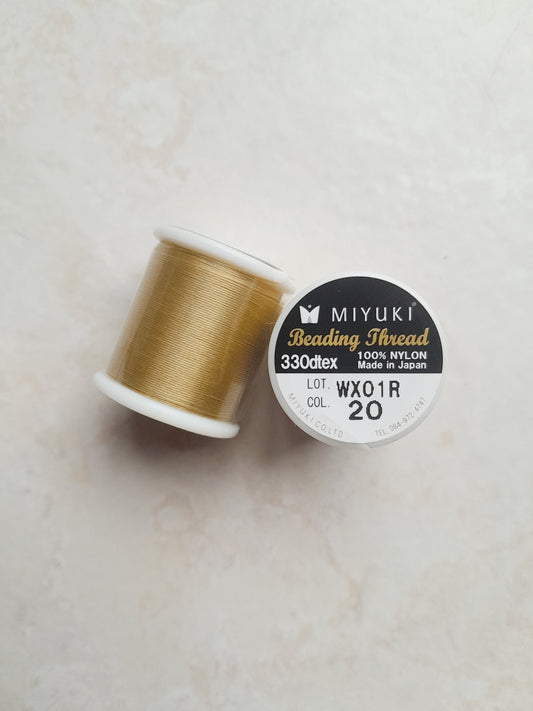 1 bobine de 50m fil nylon MIYUKI couleur Gold champagne 20